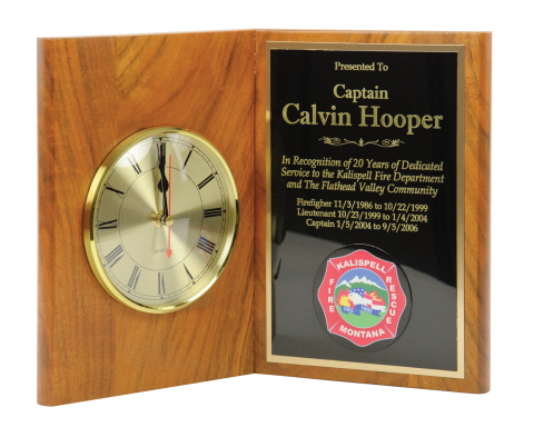 Solid walnut book plaque 9 ½” high with 5” quartz clock and brass engraving plate. 