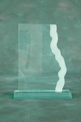 Graceful waterfall edge accents clear or jade acrylic piece on acrylic base