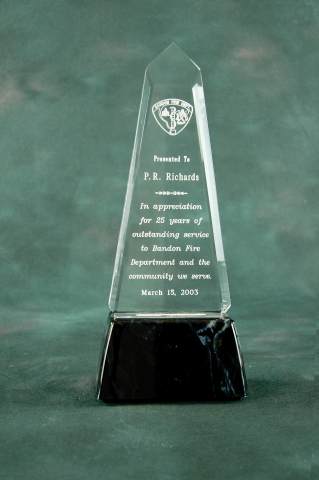 This elegant shape is a unique recognition award, mounted on a black marble finished base.